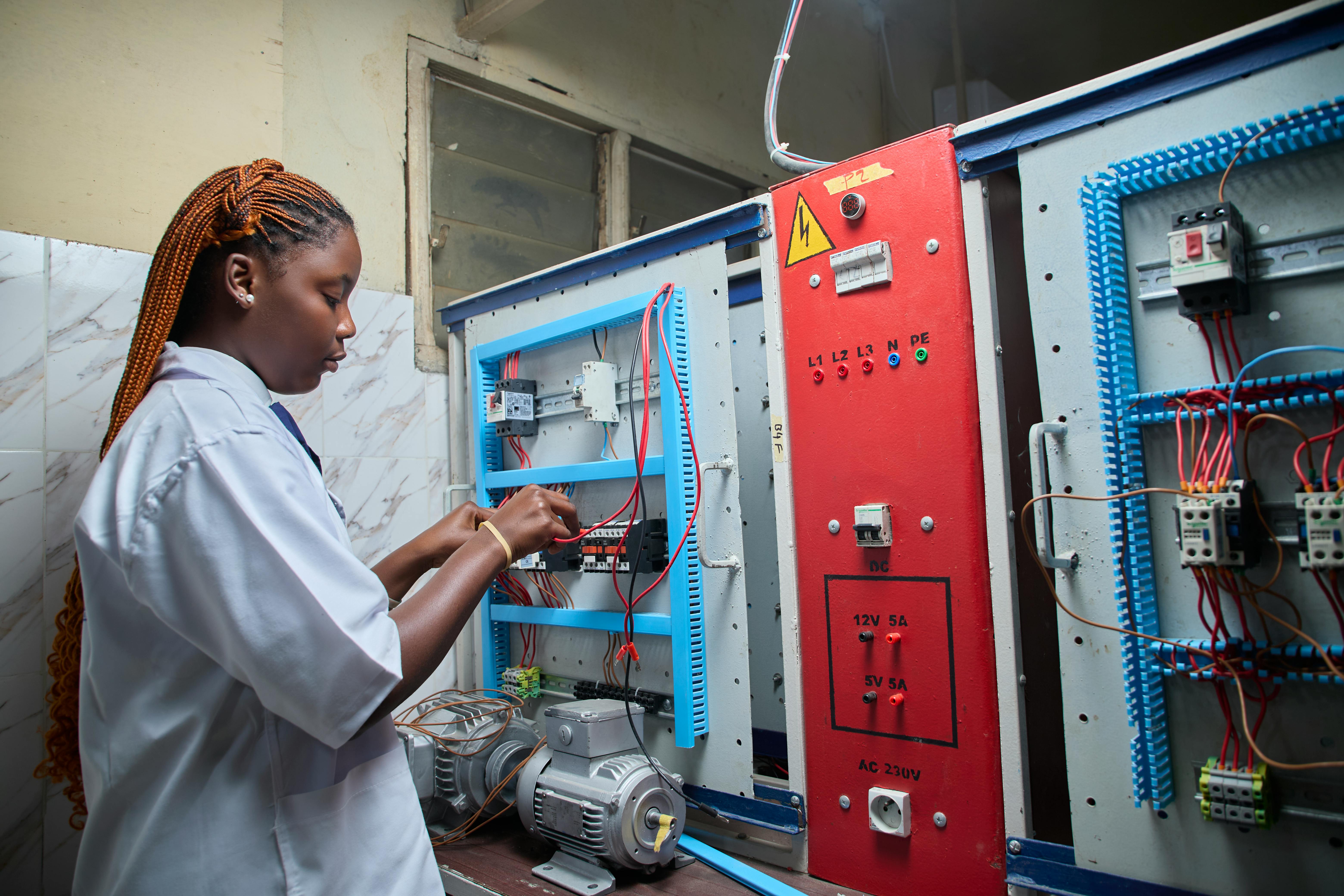 Technician working inside an industrial electrical panel